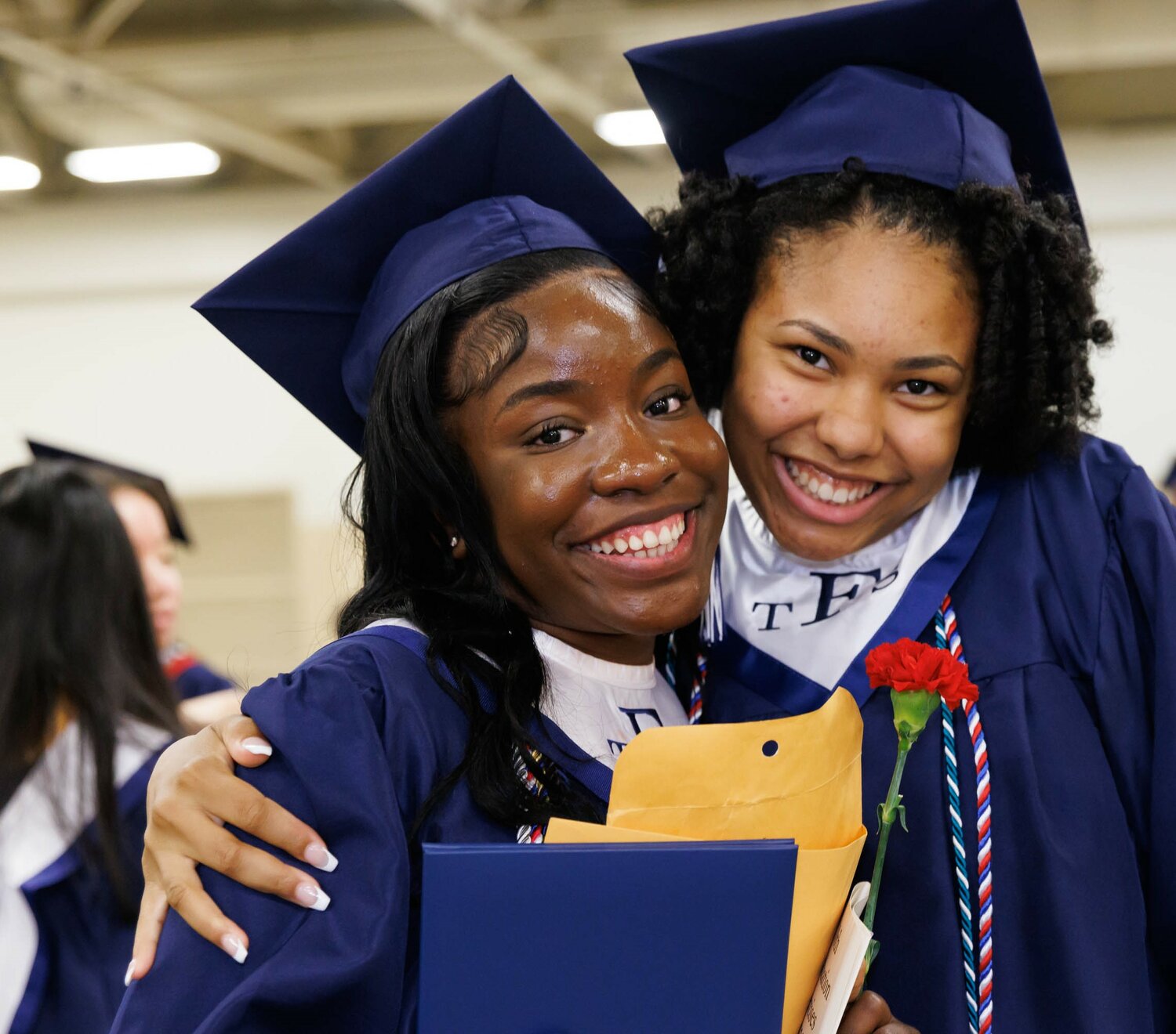 Graduates congratulate each other at the Terry Sanford High School 2023 commencement Wednesday at the Crown Coliseum.
