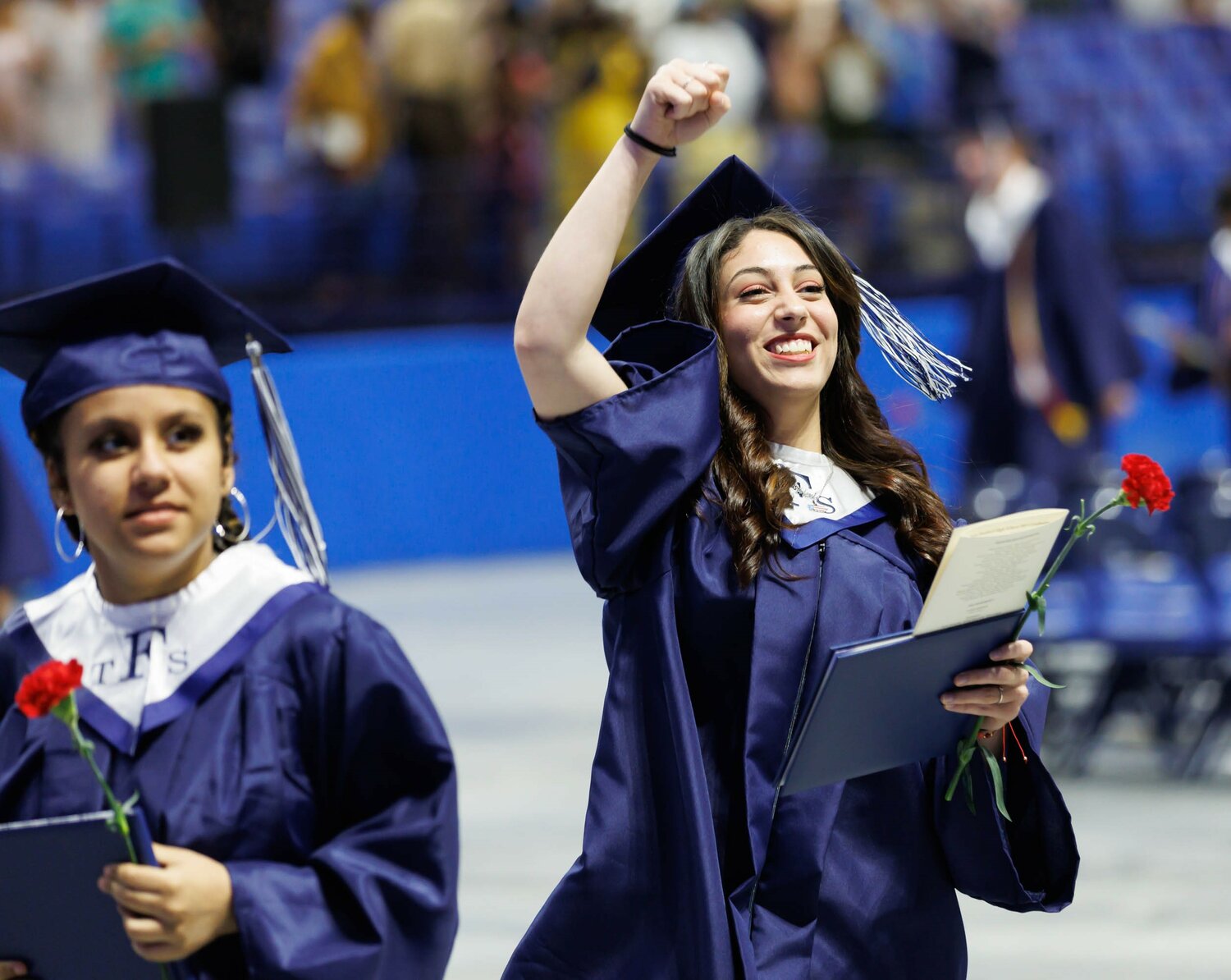 A fist bump seals the deal for one graduate at the Terry Sanford High School 2023 commencement Wednesday at the Crown Coliseum.