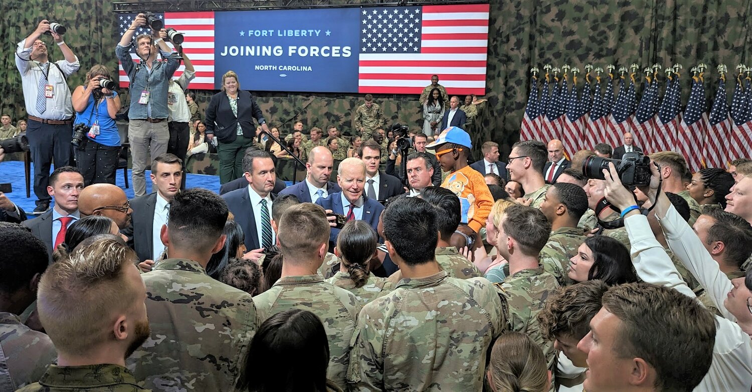 President Biden mingles with military personnel and families on Fort Liberty on Friday after signing an executive order on support for military families.