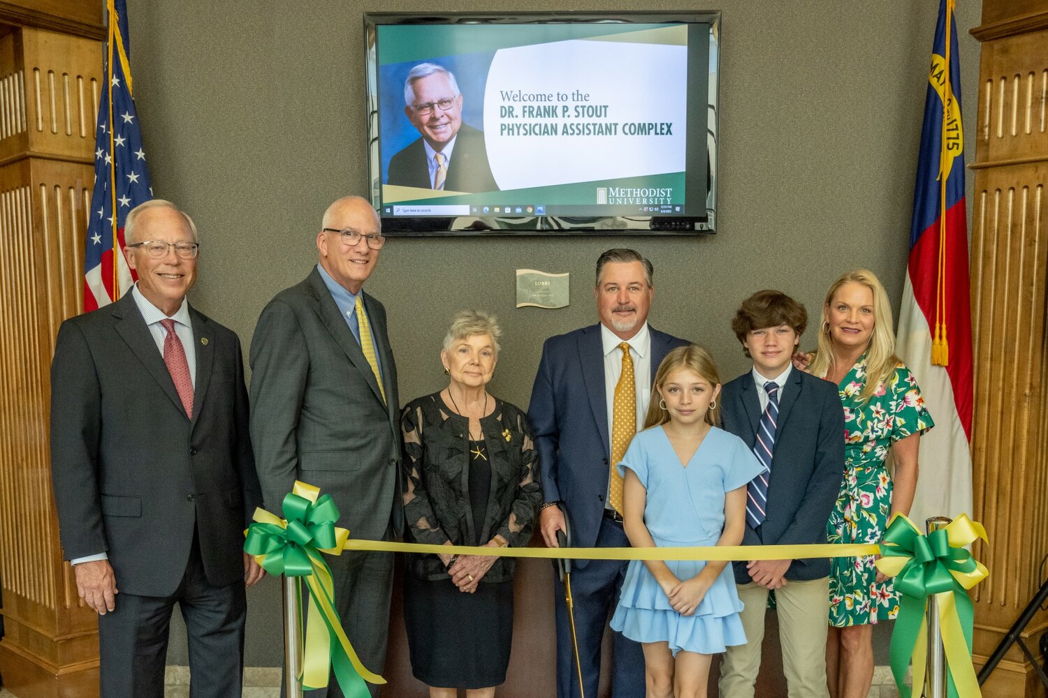 Tim Richardson, vice chairman of the Methodist University board of trustees, left, and university President Stanley Wearden stand with members of the Stout family during a dedication of the Dr. Frank P. Stout Physician Assistant Complex. Stout's widow, Carol Stout, is shown with their son, Cam Stout; granddaughter, Cameron Stout; grandson, Craven Stout; and daughter-in-law, Kelly Stout.
