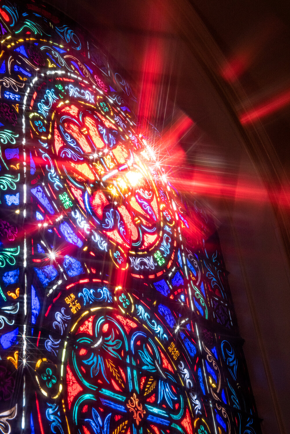 Rays of morning sunlight are reflected in a stained-glass window inside Fort Liberty's Main Post Chapel.