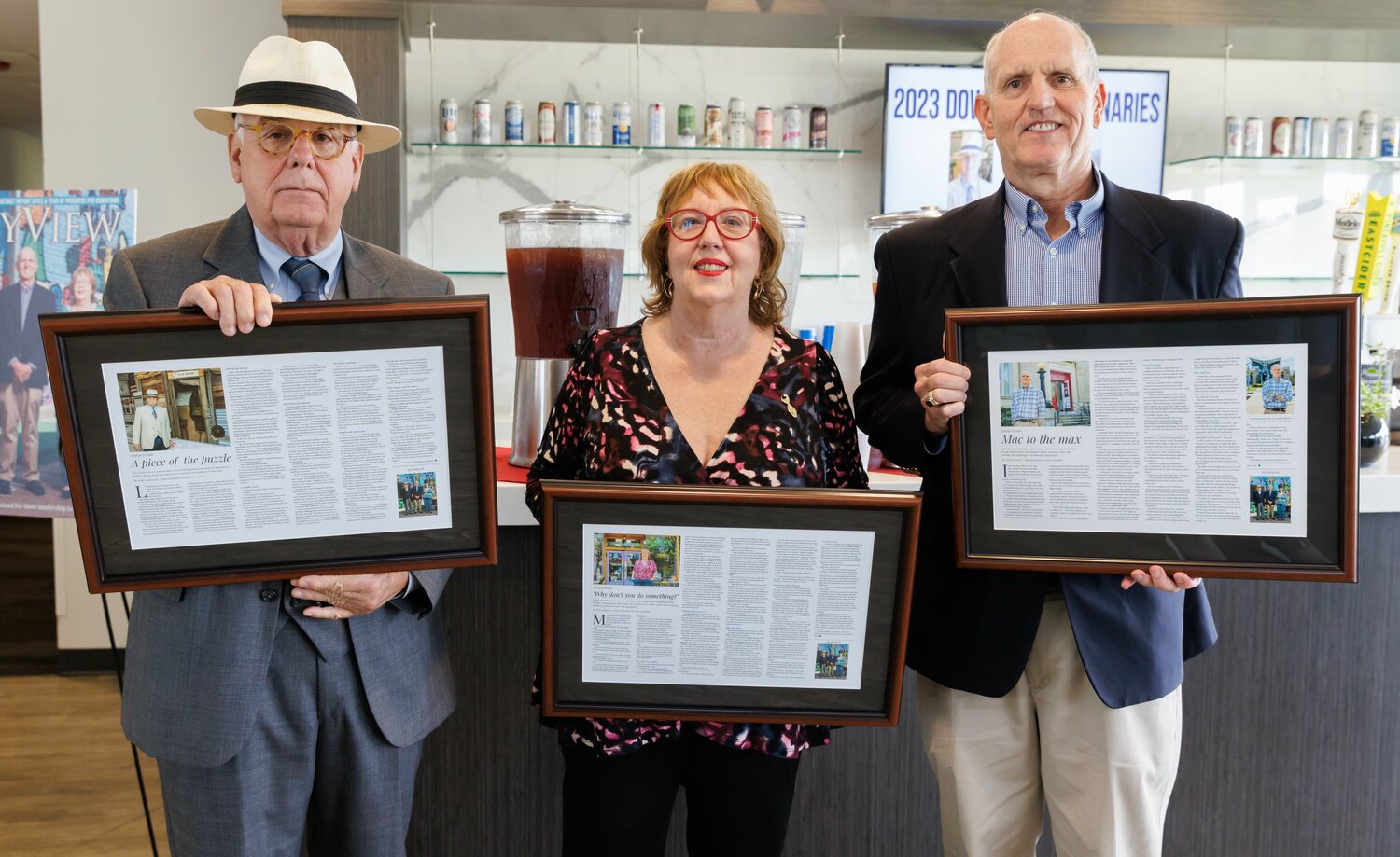 Bruce Daws, left, Molly Arnold and Mac Healy hold their Downtown Visionaries awards, which were presented by CityView magazine on Thursday at Segra Stadium.