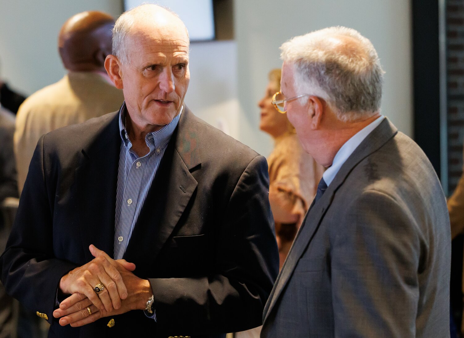Downtown Visionaries award recipients Mac Healy, left, and Bruce Daws chat during the luncheon honoring them and Molly Arnold on Thursday at Segra Stadium.
