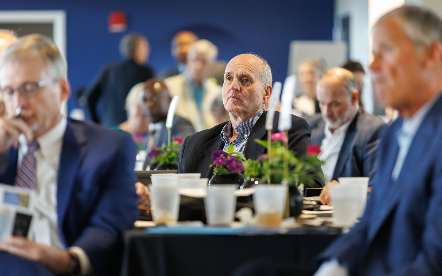 Mac Healy listens from the audience during the third annual Downtown Visionaries awards luncheon Thursday at Segra Stadium.