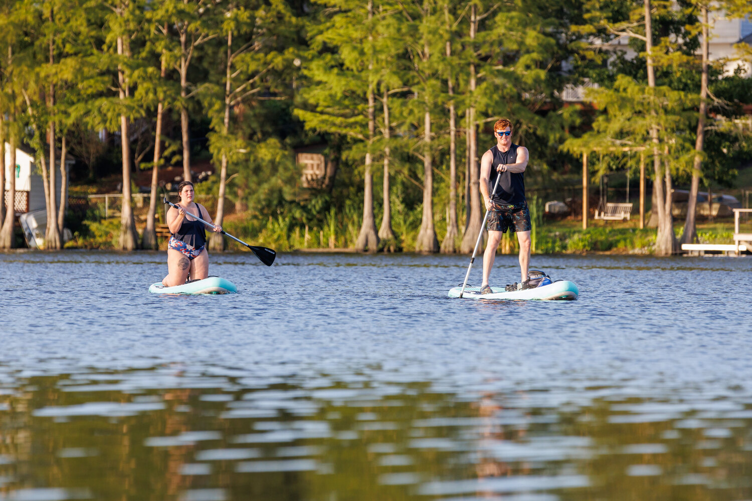 Local paddle boarders visited Hope Mills Lake to cool down as the temperature approached 100 degrees on a recent afternoon.