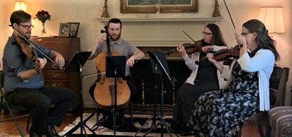 Clark Spencer on viola, Jesse Smith on cello, and Holland Phillips and Megan Kenny on violin perform ‘Legacy of Love’ for Frances Grimes’ 100th birthday celebration.