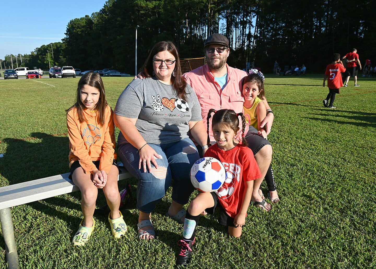 Amanda and Jonathan Price of Orrum attend a soccer game with their three daughters.