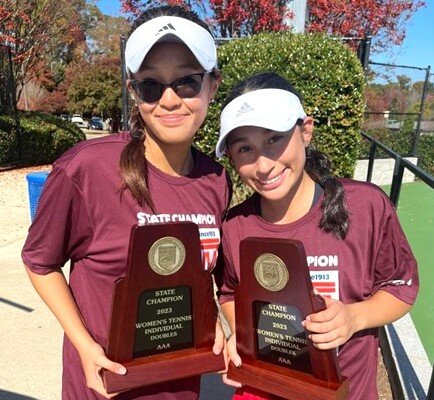 Terry Sanford's Pauline Bui, left, and Loren Galaviz are the state women's tennis doubles champions.