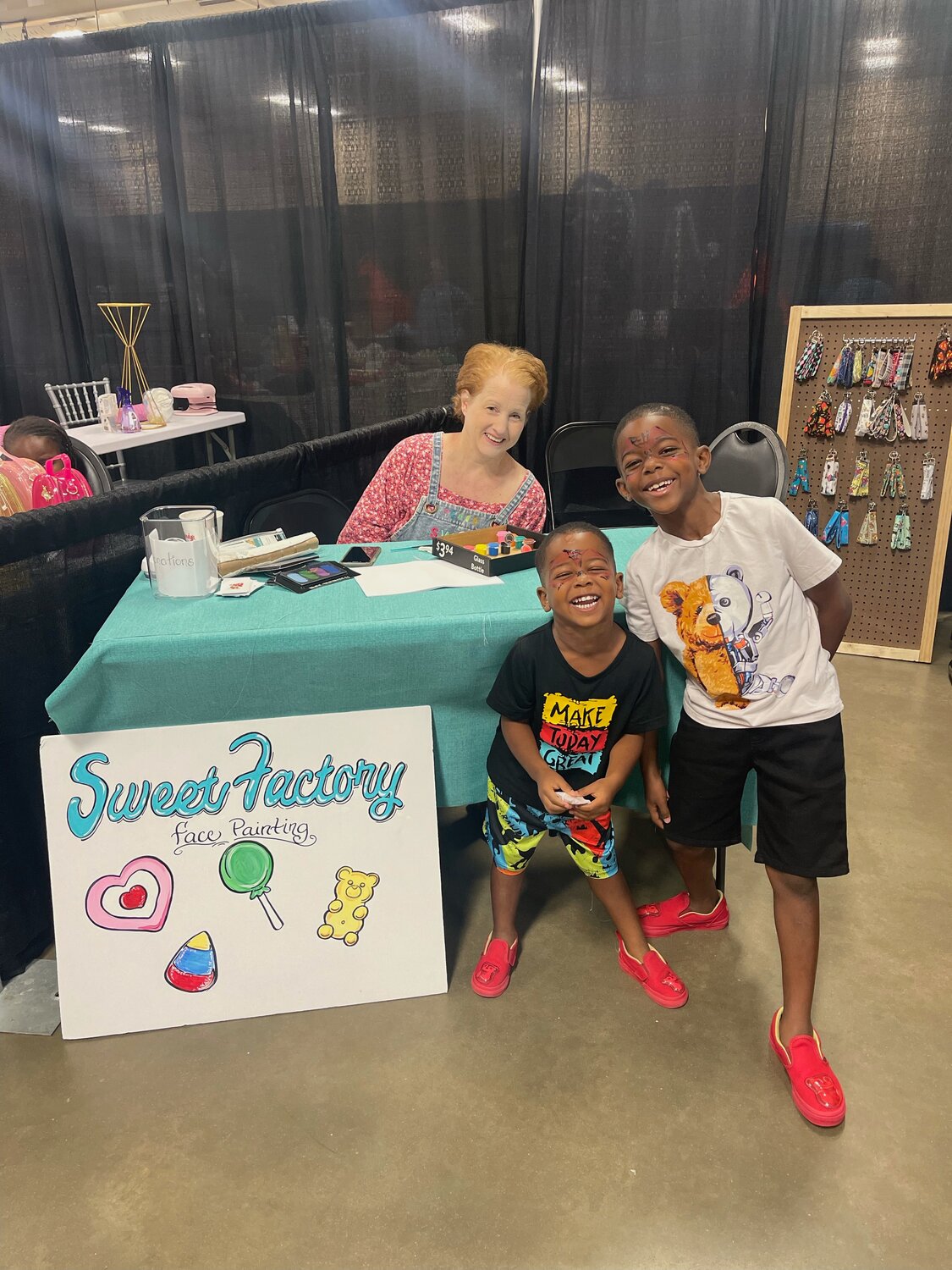 Carter Blount (right), the 8-year-old son of Sweet Factory's owners, poses with younger brother Cairo and local artist Stephanie Mollett.