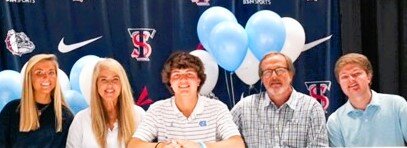 Ethan Paschal, center, is surrounded by his family at his signing ceremony to play golf at UNC in the Terry Sanford High School Auditorium. From left are his sister, Annie Paschal; mother, Kim Paschal; father, Michael Paschal; and brother, Jackson Paschal.