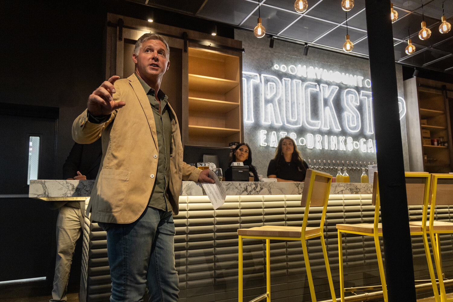Jordan Sherrod, co-owner of the new Haymount Truck Stop bar and food truck court, speaks during the bar’s soft opening on Wednesday.