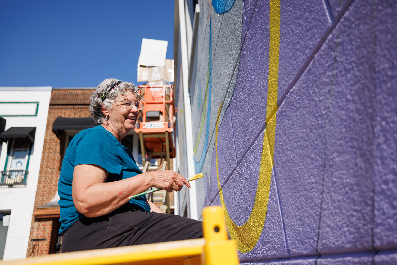 Patsy painted the yellow ribbon emerging from "Lady Muriel's" dress. “We’ve loved seeing the new murals around town, and we wanted to be part of that,” Patsy said about her hopes for the mural.
