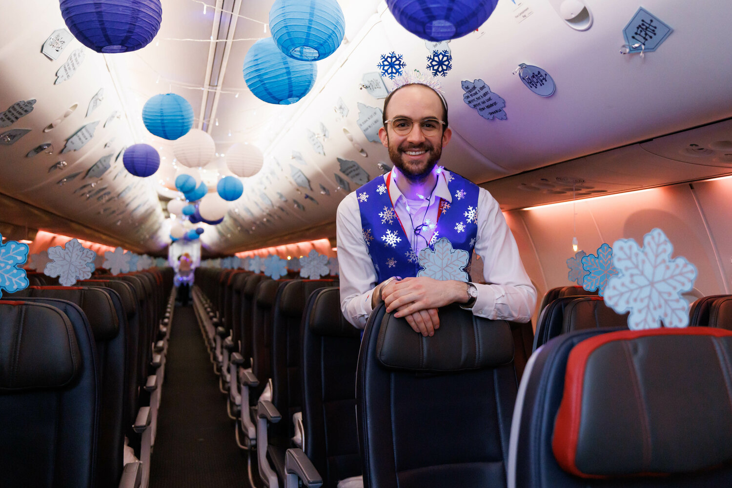 American Airlines crew member Benjamin Reid makes the last of preparations to the cabin of the Snowball Express as family members prepare to board on Dec. 2, 2023.