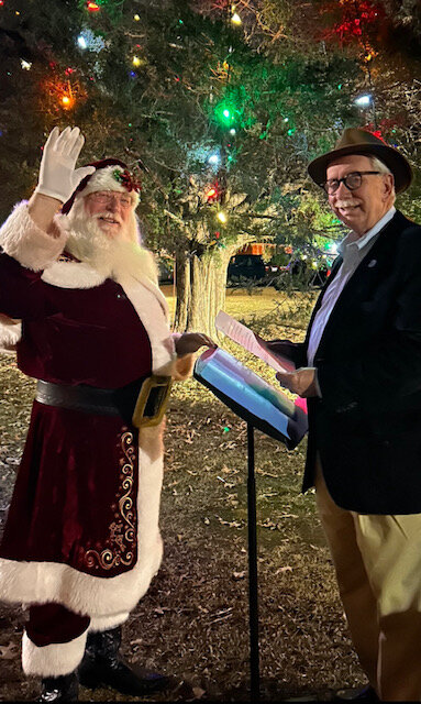 Saint Nick, aka Dwayne Dunning, is sworn in as a Falcon town commissioner by former Cumberland County District Court Judge Talmadge Baggett.