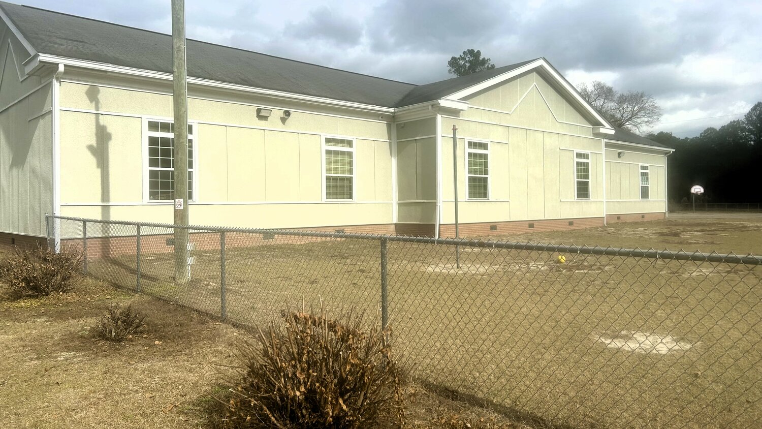 A side view of Beaver Dam Elementary School shows window exteriors and timber-framing that display signs of lead paint. The school district has said it is working with the health department to cover the hazardous areas.