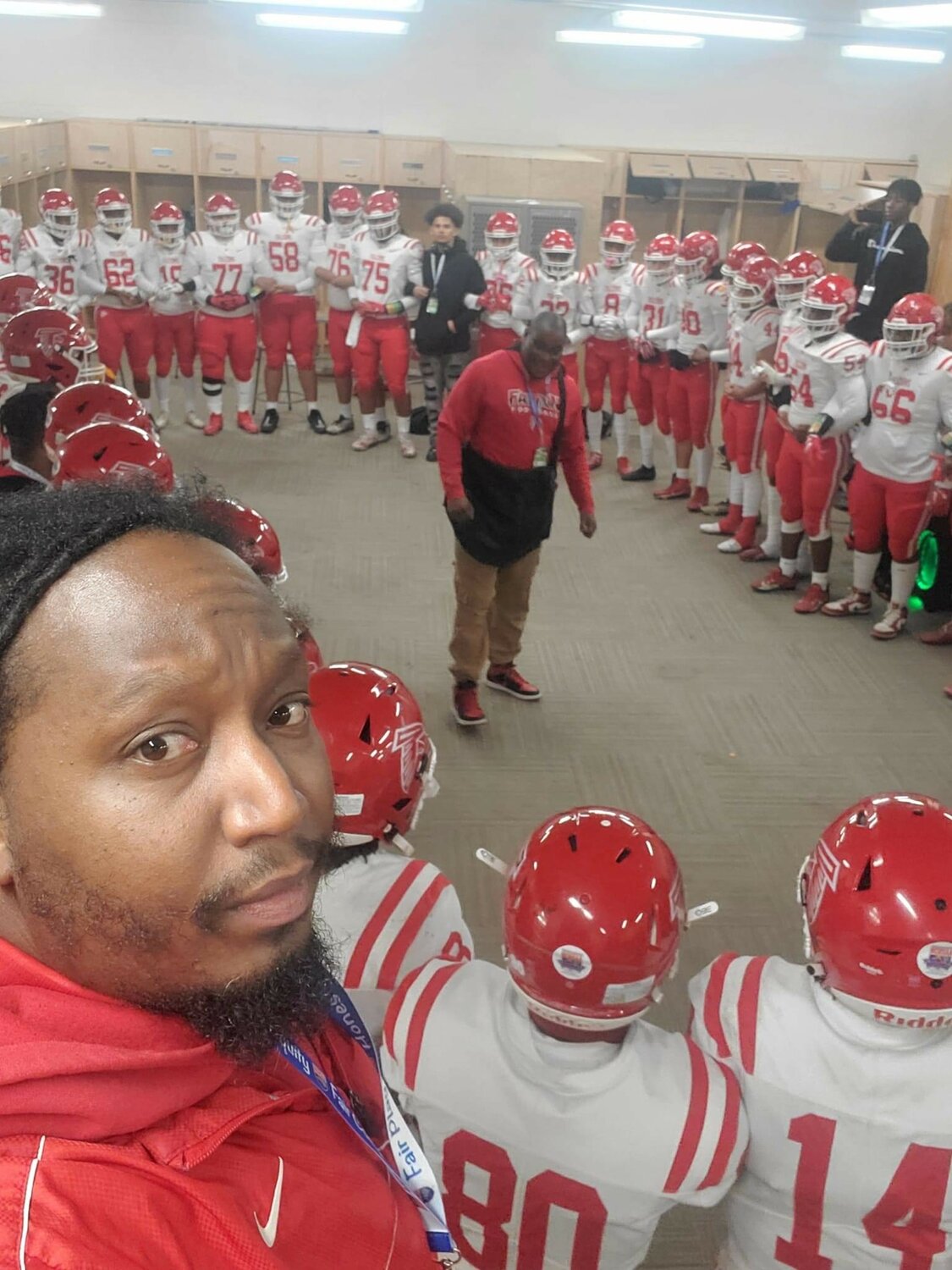 Seventy-First Assistant Coach Eric Hall (pictured center) addresses the team before the game Friday in their locker room at UNC-Chapel Hill's Kenan Stadium. Assistant Coach Anthone Harris is pictured in the foreground.