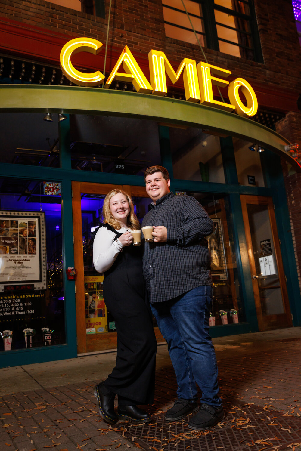 Katelyn Wood and Hunter Hicks celebrate their engagement with coffee from Rude Awakenings as they pose for a portrait outside of the Cameo Art House Theater. The two chose downtown Fayetteville as it represents a portion of their courtship. Katelyn, an RN-BSN pediatric nurse at Cape Fear Valley, and Hunter, a youth director at Arran Lake Baptist Church, were married on Sept. 16, 2023.