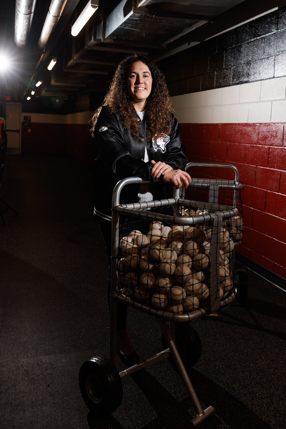 Michelle Skinner, General Manager for The Fayetteville Woodpeckers, poses for a portrait in the tunnel players take when accessing the infield of Segra Stadium.