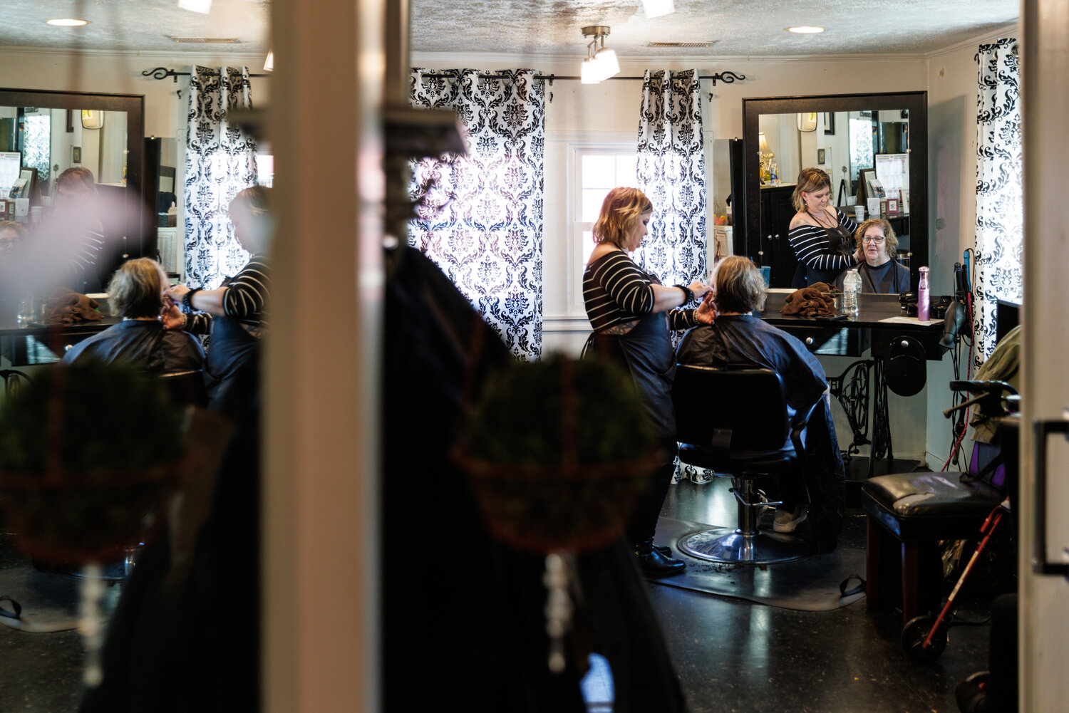Ashley Culberth works on a client's hair inside Scissors on Marlborough salon.