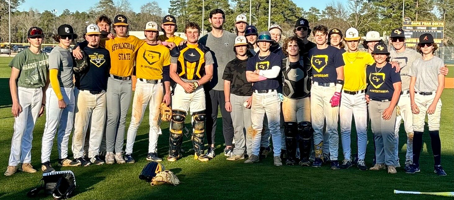 Gavin Williams (center with gray shirt) poses with the Cape Fear baseball team.
