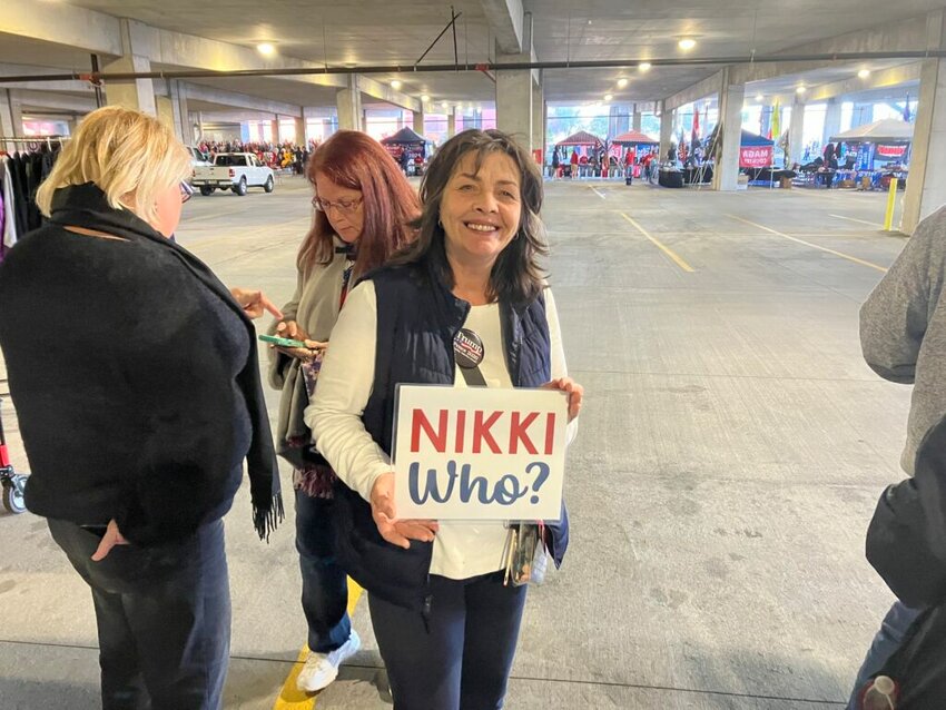 Kim Cessna poses with her “Nikki Who?” sign in line for Donald Trump’s rally in North Charleston on Feb. 14, 2024.