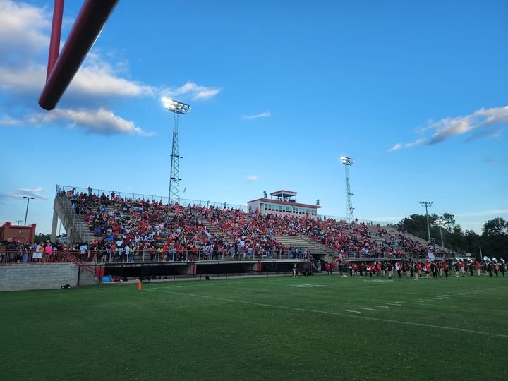 PHOTO: The home stands at Wilder Stadium as the combined Clinton-Laurens marching bands take the field in pre-game, county rivalry game activities. - Photo by Vic MacDonald