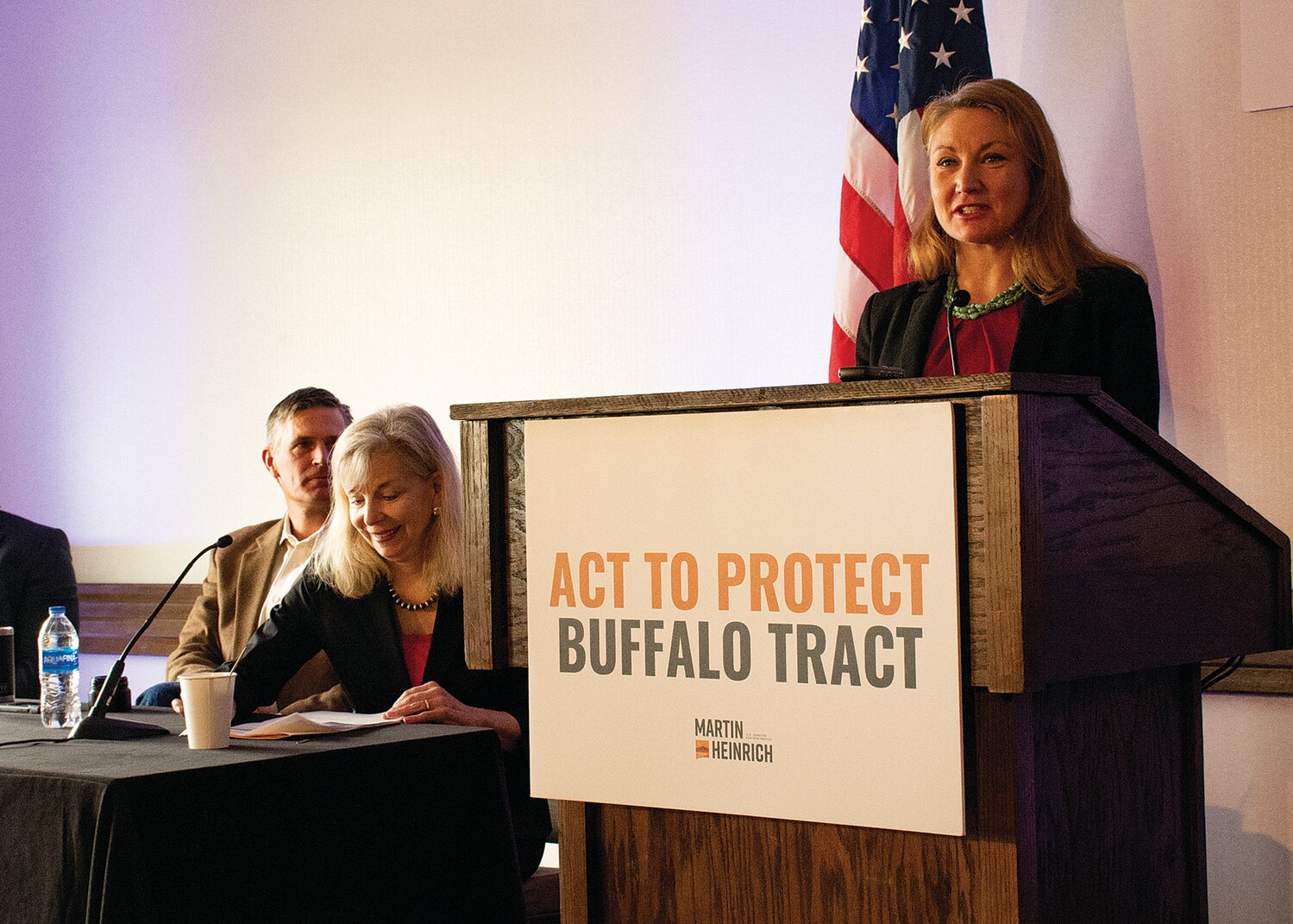 First Congressional District Rep. Melanie Stansbury speaks during a March 17 event promoting passage of the Buffalo Tract Protection Act she introduced in the House to ban mining on federal lands in Placitas. Listening are Sen. Martin Heinrich, sponsor of the Senate version of the bill, and Mary-Rose de Vallardes, chair of the Placitas-based Land Use Protection Trust. (Bill Diven/Sandoval Signpost)
