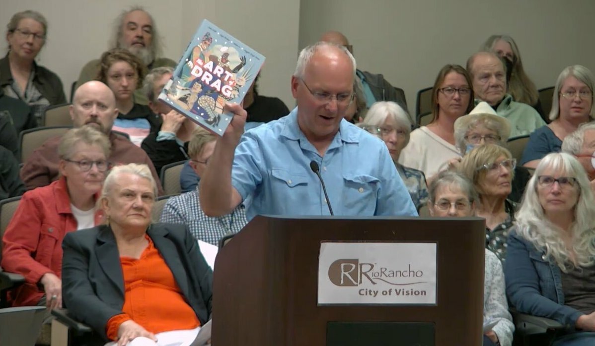 Michael Jackovich holds up one of the books he'd like to see banned from Rio Rancho libraries.
