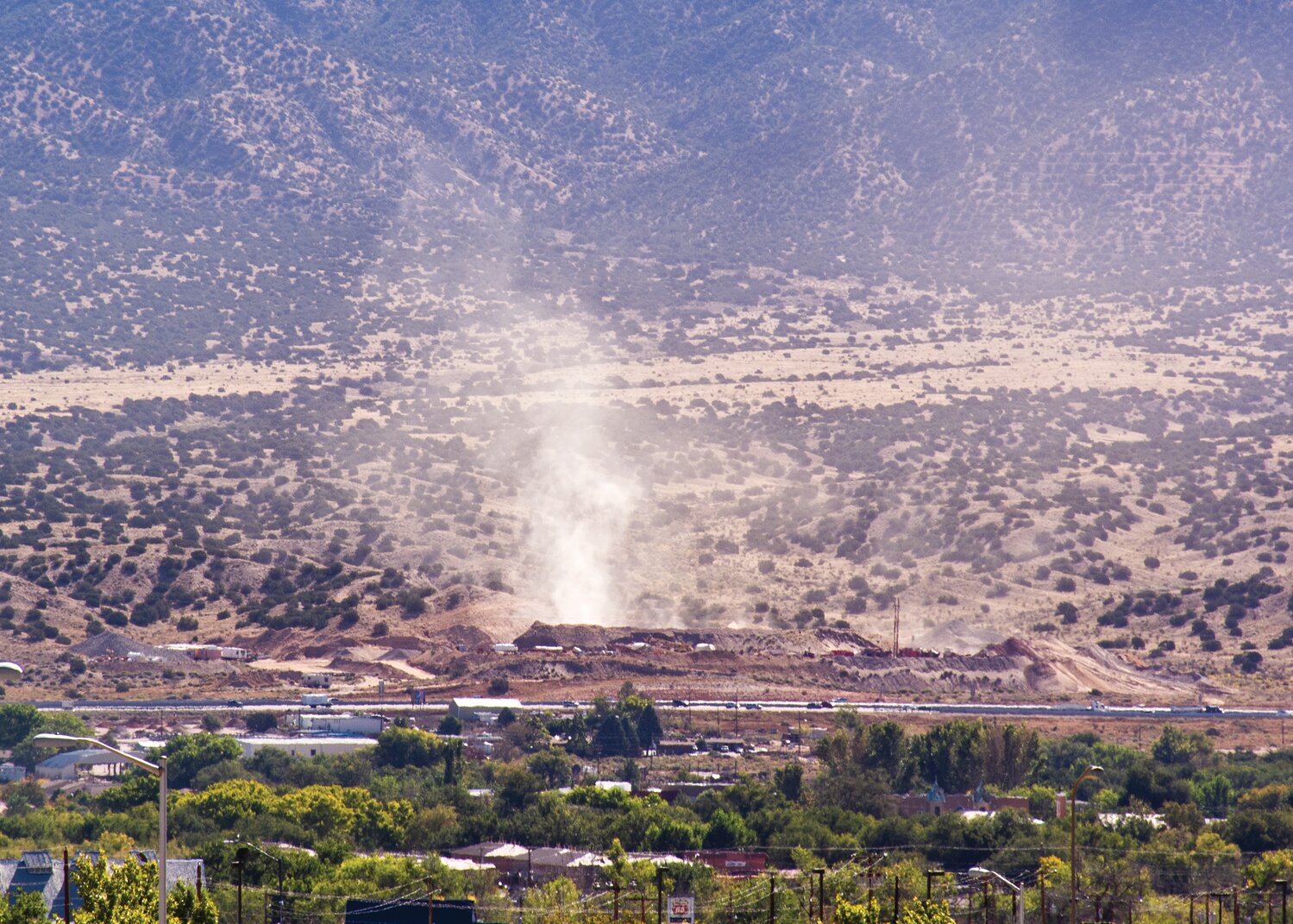 A dust cloud drifting toward Placitas in late 2015 rises from the Fisher Sand & Gravel quarry in Bernalillo several months after operations began in 2015. (Bill Diven/Sandoval Signpost)