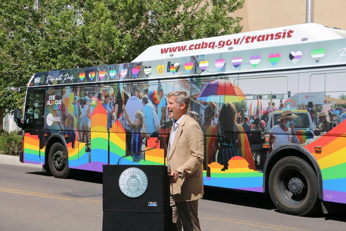 Mayor Tim Keller, City Councilor Pat Davis and city staff roll out a special bus wrap for pride 2023.