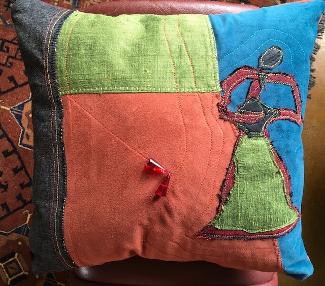 A pillow by Lee Small, left, imitates the work of Joan Miro, right.