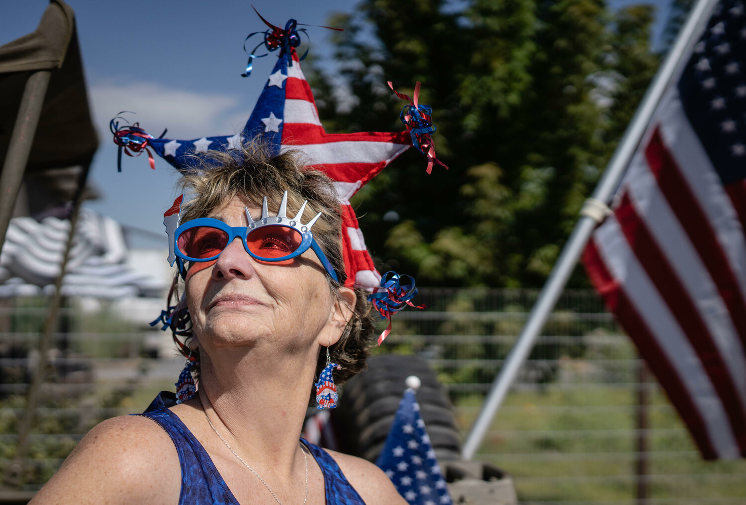 Jana Dyck, dons her patriotism  while standing on the sidewalk along Corrales rd. during the annual Corrales Fourth of July Parade. (Roberto E. Rosales/Corrales Comment)