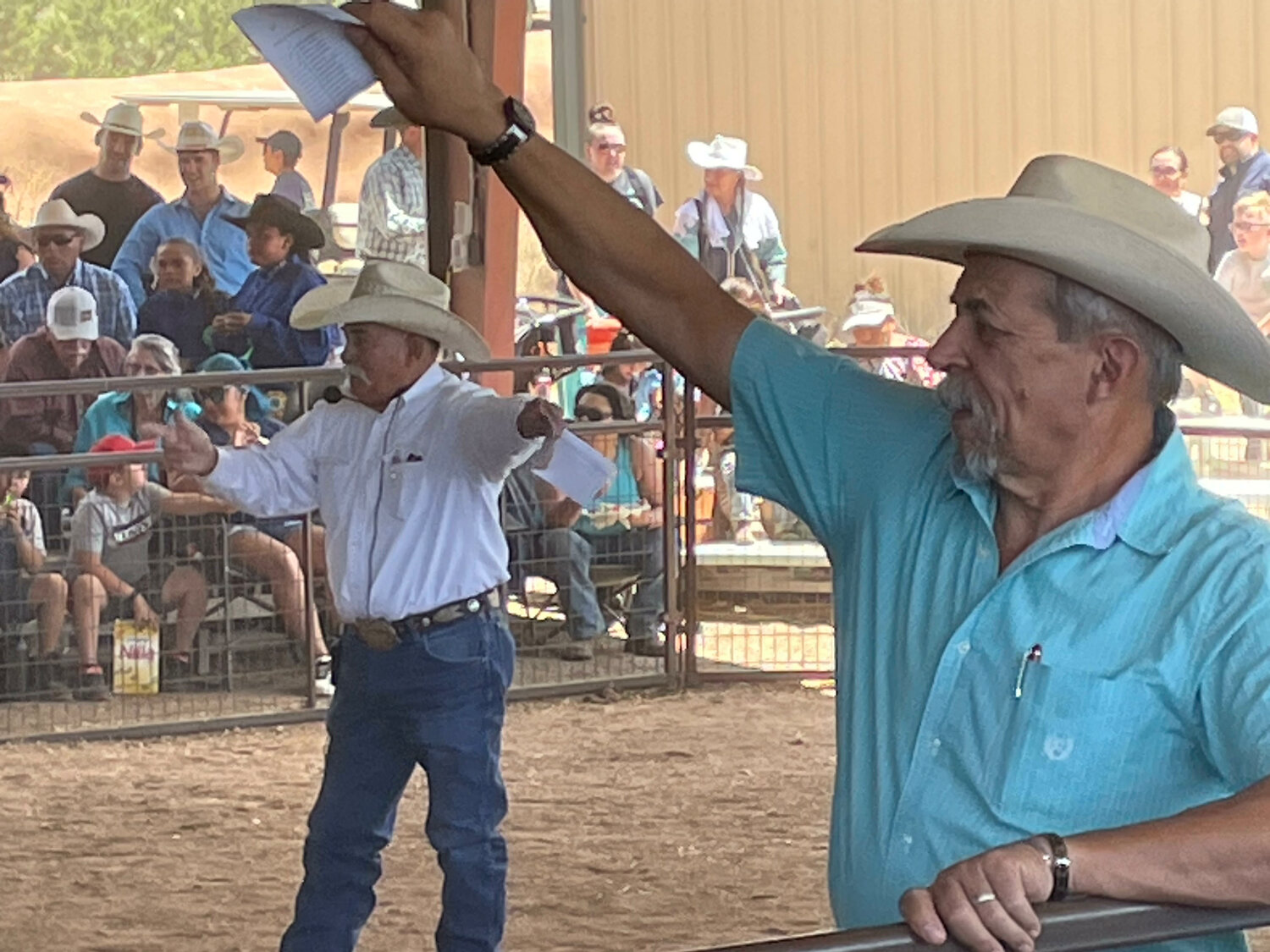 The Junior Livestock Auction is always one of the highlights of the county fair. Here, auctioneer Leroy Lovato (background) solicits funds with help from ring man Richard Herrera.