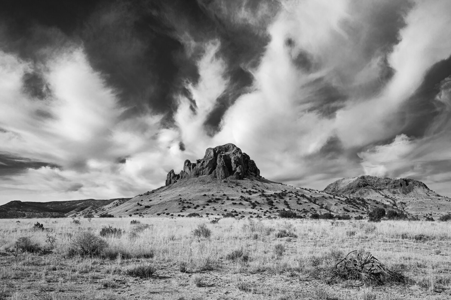 Photographer John Wylie's photo of "Clouds Over Cerro de Guadalupe" is one of many of his photographs of the Rio Puerco Valley on exhibit at Albuquerque's Open Spaces Visitors Center through Sept. 23. (Courtesy photo)