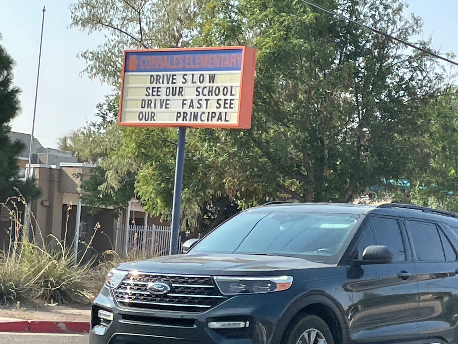 Borrowing from a sign that used to appear in the village, Corrales Elementary School urges motorists to drive at safe speeds.