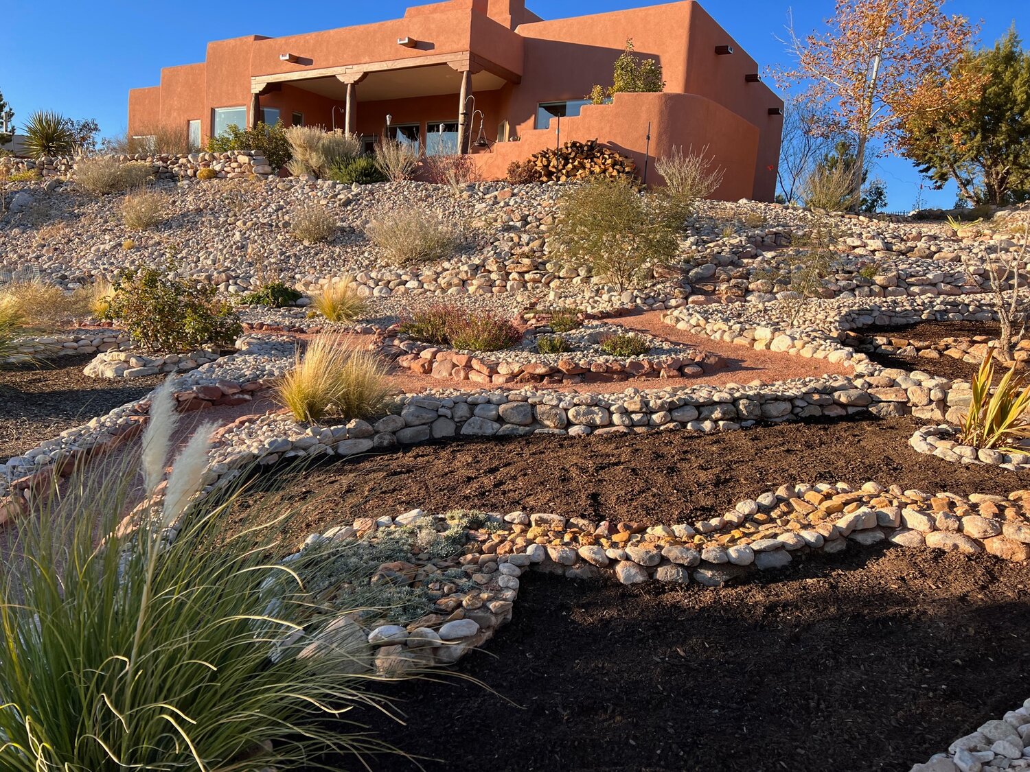 Yin and Hensley Terrace Back Property:
Rock lined terracing at the Flowing Garden diverts rain water and helps with erosion control.