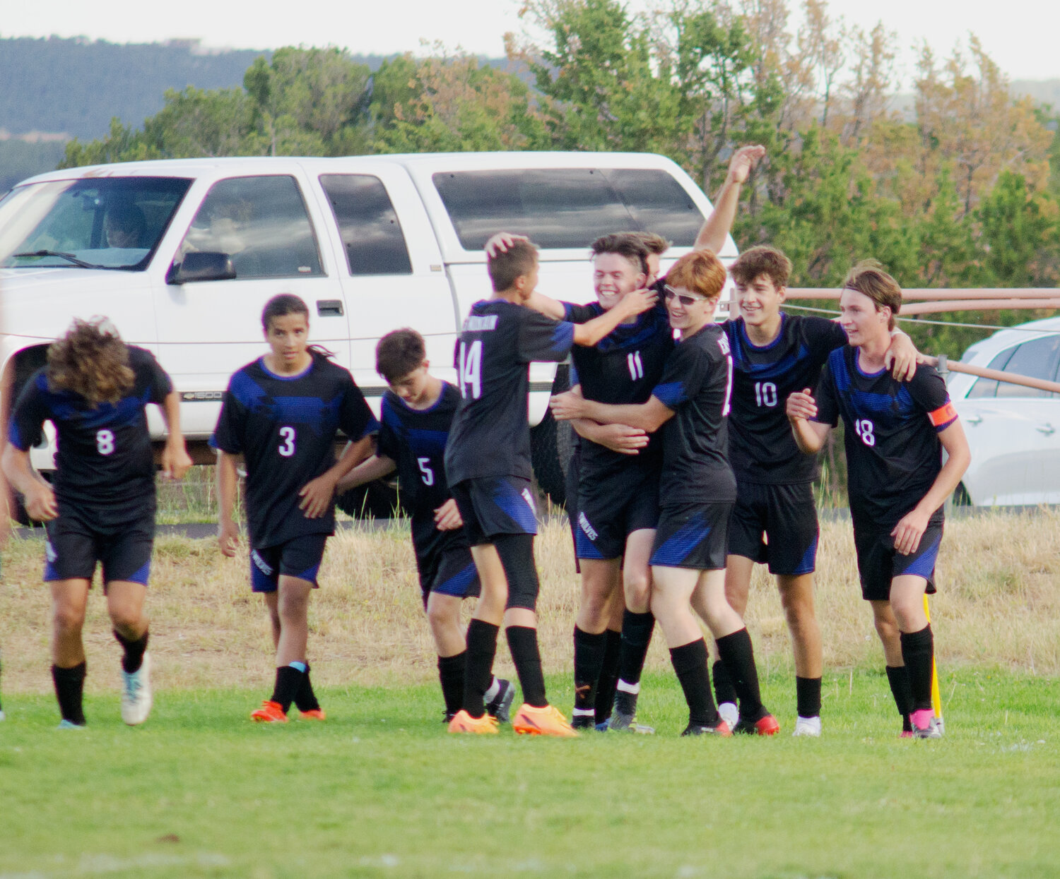 Trevor Head (11) celebrates a goal with his east Mountain teammates. It is a scene that would replay itself many times this season.