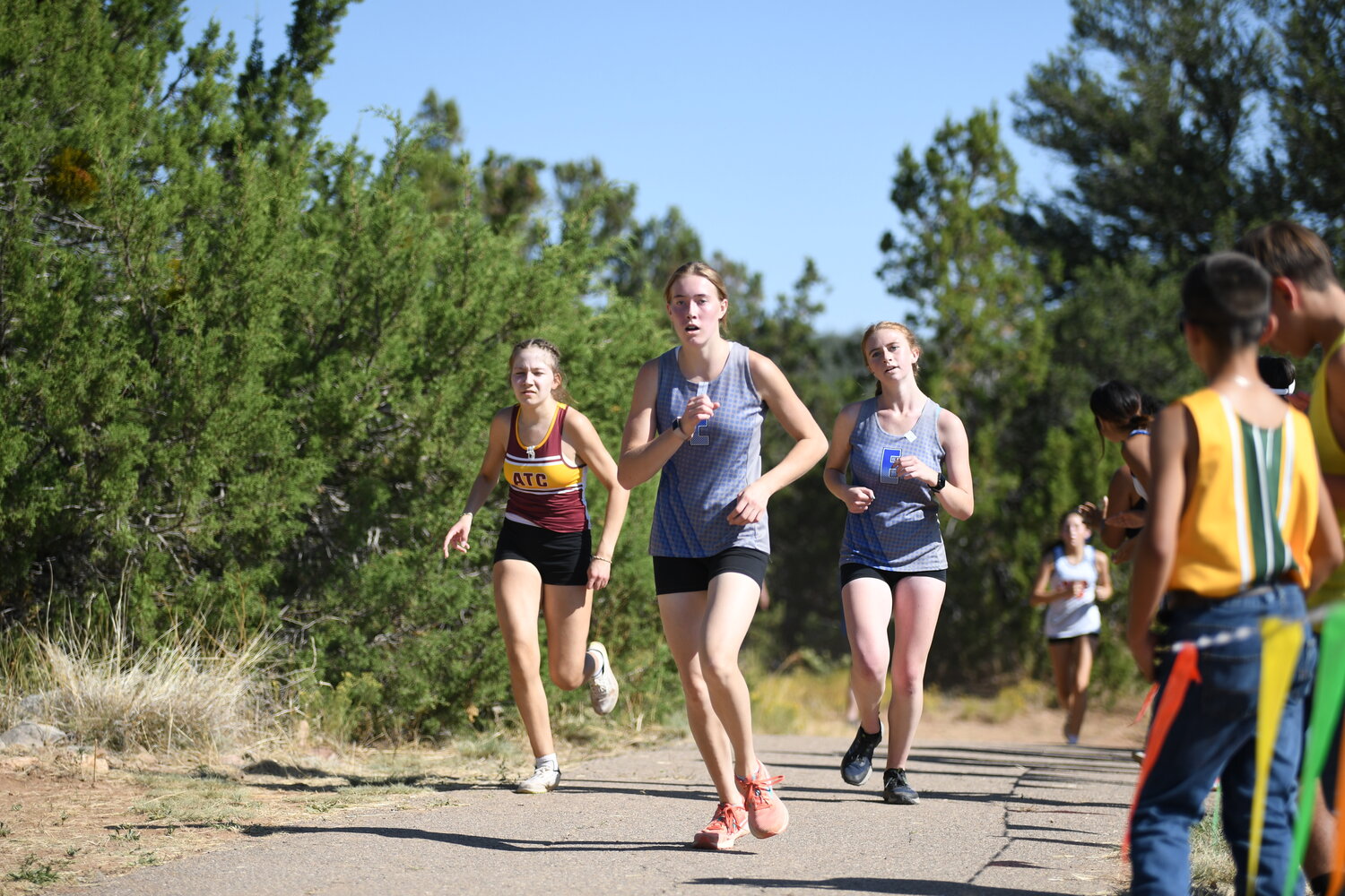 East Mountain's Ruth Trullinger, center, pulls ahead of teammate Verity Gray, right, and a runner from ATC-Santa Fe in the varsity girls race at last week's Nick Martin Memorial Invite.