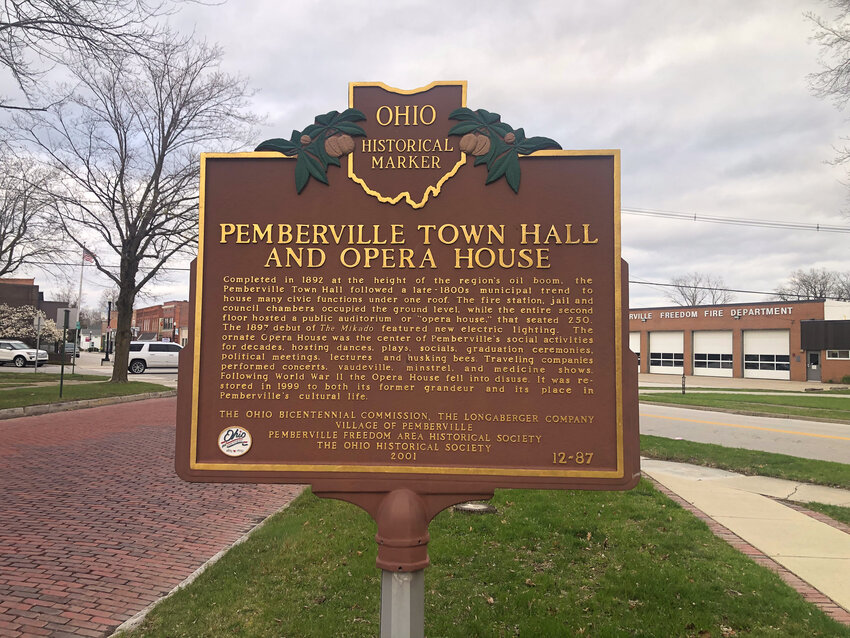 An Ohio historical marker sign is shown outside the Pemberville Town Hall and Opera House building in Pemberville, Ohio.
