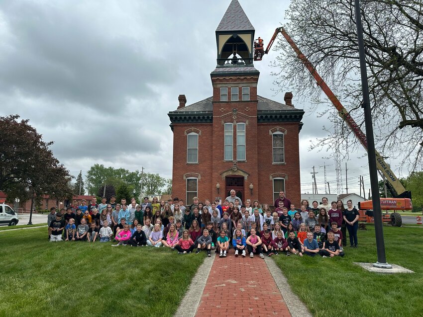Genoa elementary-aged kids pose in front of the town hall building on May 6.