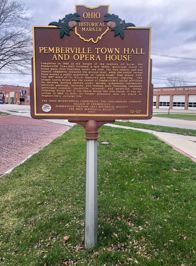 An Ohio historical marker sign is shown outside the Pemberville Town Hall and Opera House building in Pemberville, Ohio.