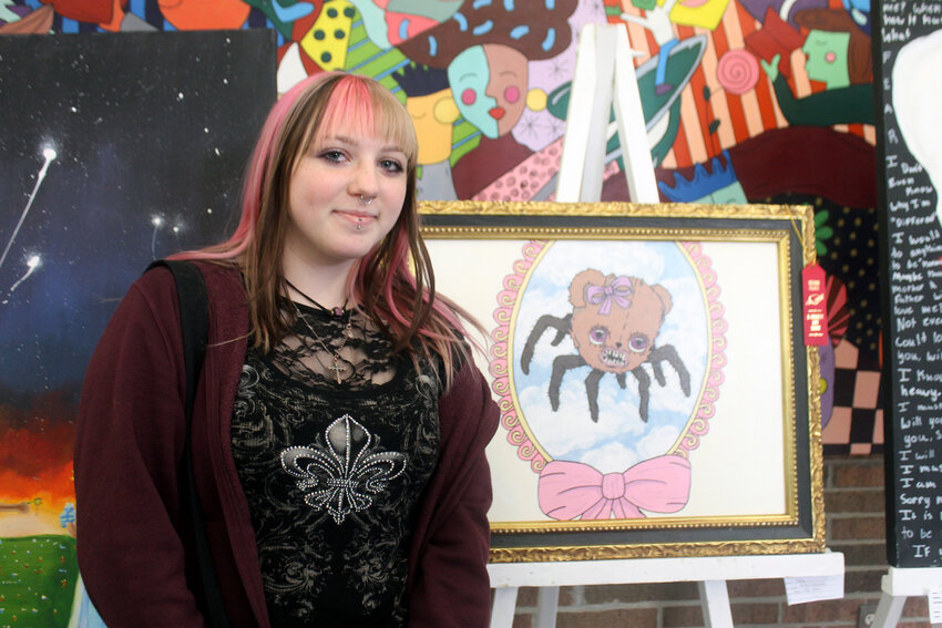 Avery Maluchnik, a senior from Genoa High School pictured above, is shown with one of her pieces of art, where she earned honorable mention recognition in ceramics and painting acrylics (objective and figurative) categories.