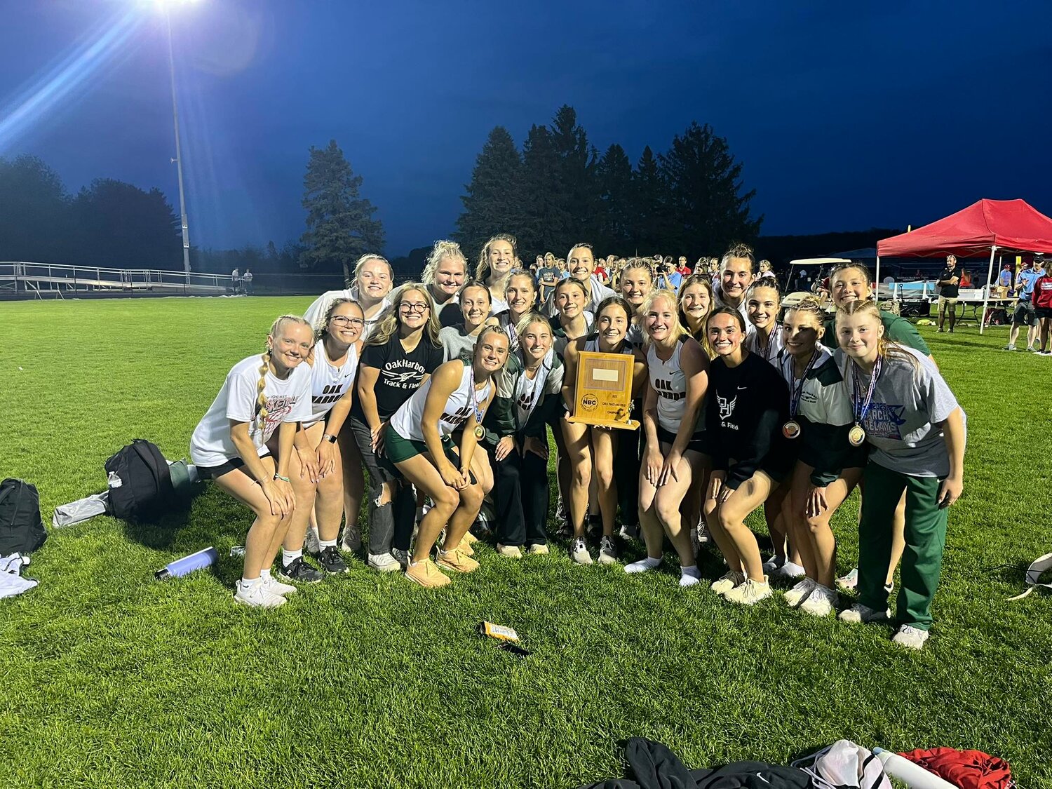 The Oak Harbor girls track team celebrates their NBC championship.