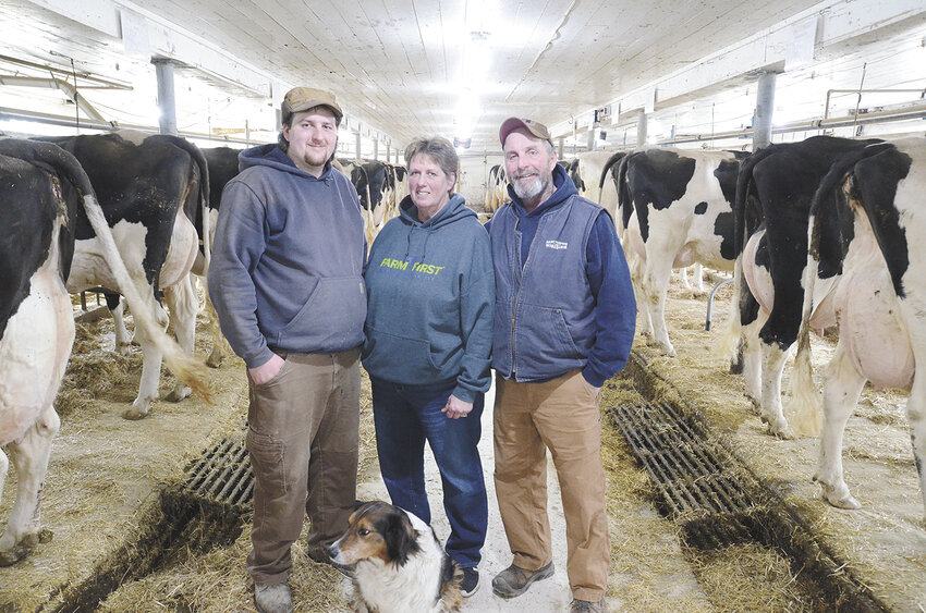 Austin (from left), Julie and Dan Vandertie stand in their tiestall barn March 7 on their farm near Brussels, Wisconsin. The Vanderties milk 40 cows and farm 400 acres and are preparing to pass the farm on to Austin.