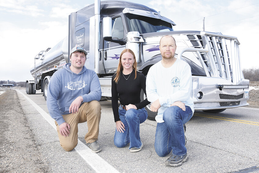 Tanner Rohner (from left), Taylor Rohner Swart and Darren Swart gather by Darren’s truck April 2 near Pennock, Minnesota. The three family members are milk haulers.