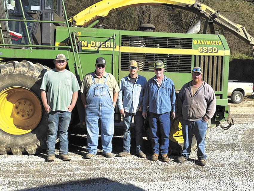 Owners and employees of Triple R Dairy (from left) Hunter Putnam, Steve Ross, Jacob Clarke, Dan Ross and Phillip Ross stand near a chopper on their farm near Waynesville, North Carolina. The Ross family suffered damage to their dairy due to Hurricane Helene.