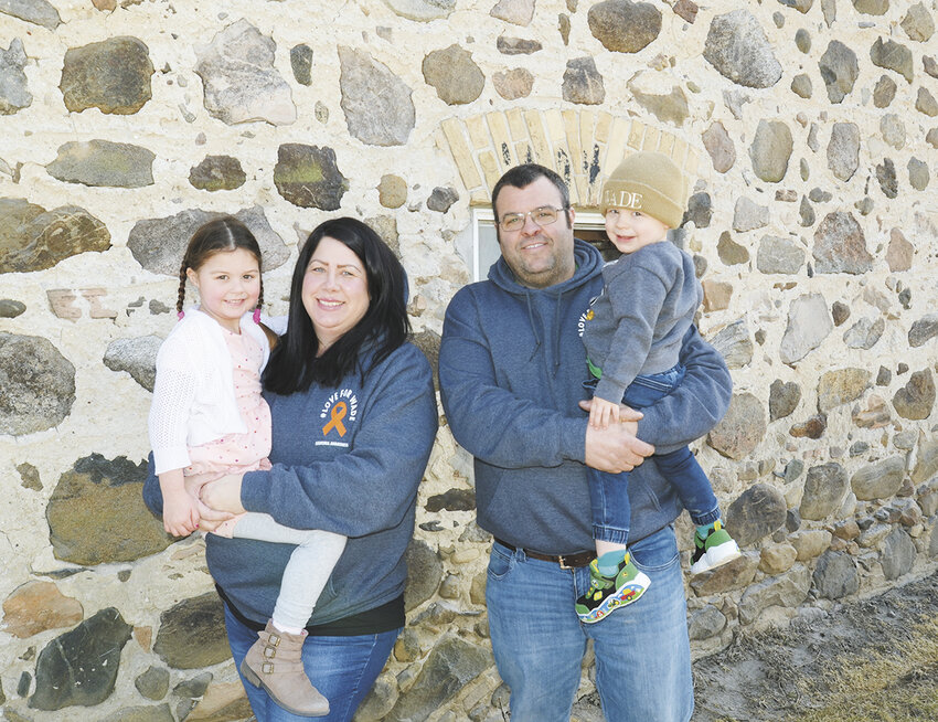 The Muth family — Gina holding Josie and Peter holding Wade — gathers outside the barn March 13 at Cedar Lawn Farm near West Bend, Wisconsin. Wade returned home March 4 cancer-free after spending 4.5 months in the hospital to be treated for acute myeloid leukemia.