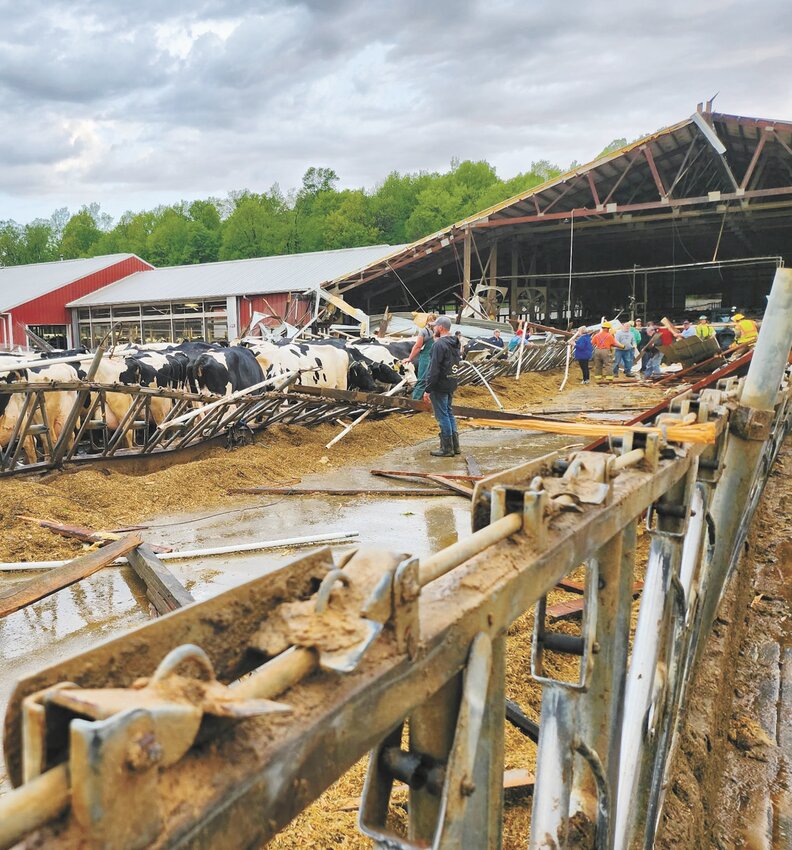 Members of the community help assess the damage May 15 after a tornado destroyed the freestall barn at Elsinger Farms near Lomira, Wisconsin. An EF1 tornado with winds up to 95 mph touched down just after 6 p.m.