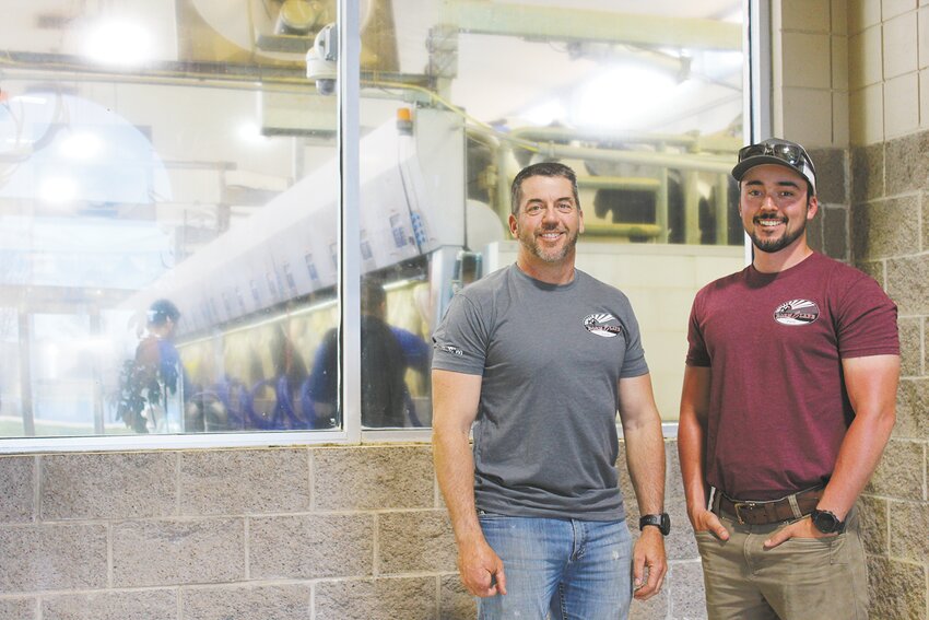 Josh (left) and Emmett Meissner take a moment May 5 in the parlor of their family’s dairy farm near Chili, Wisconsin. The Meissners milk 1,900 cows in Chili and another 1,700 cows at a second farm they recently purchased near Hillsdale.
