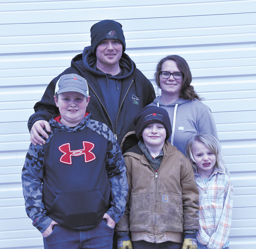 The Ley family — Logan (front, from left), Lucas and Lexi; (back, from left) Paul and Ashleigh — take a break from their daily routine Feb. 3 at their farm near Little Falls, Minnesota. The Leys milk 110 cows.